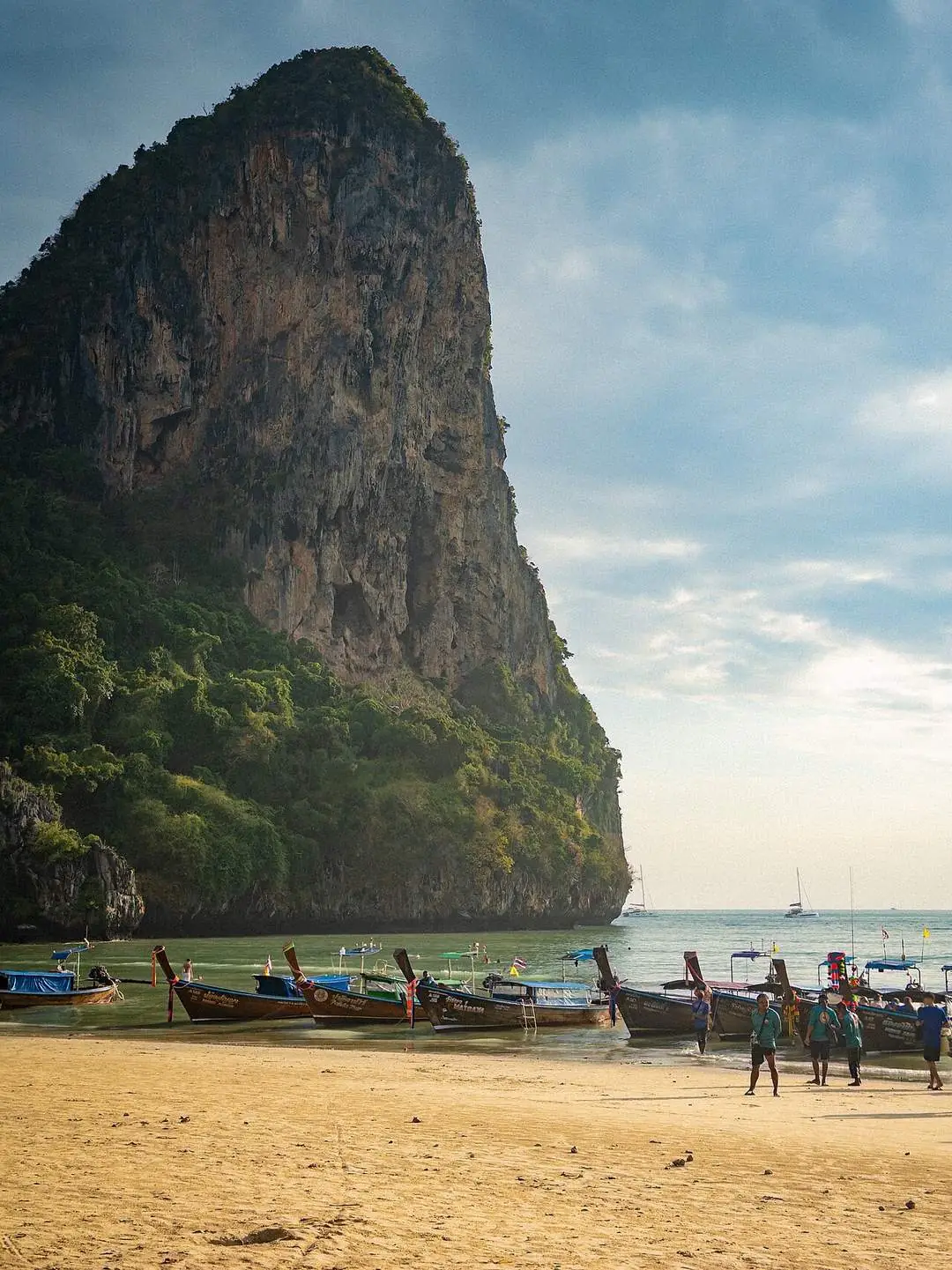Limestone cliffs and longtail boats at Railay West Beach near Ao Nang, Krabi